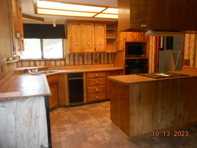 30528 Rl Smith Logging Road Oak Run, CA 96069 - Photo 11 of 22 a kitchen with stainless steel appliances granite countertop a sink stove and refrigerator