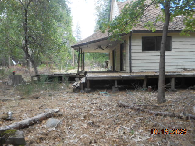 30528 Rl Smith Logging Road Oak Run, CA 96069 - Photo 21 of 22 a backyard of a house with large trees and wooden fence
