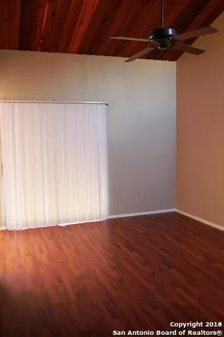 an empty room with wooden floor