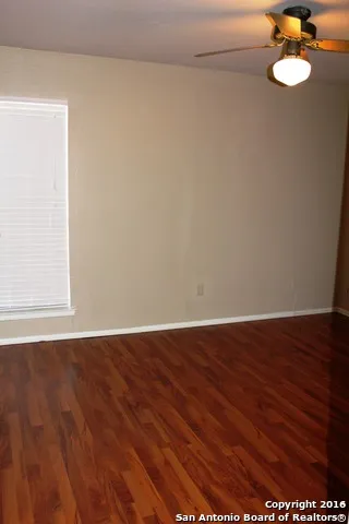 a view of a room with wooden floor