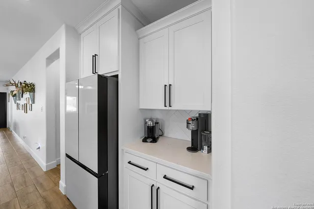 a kitchen with a refrigerator and cabinets
