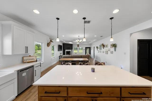 a kitchen with a stove kitchen island a refrigerator and a stove