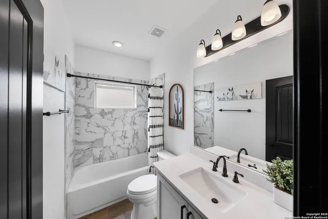 a bathroom with a sink mirror toilet and bathtub