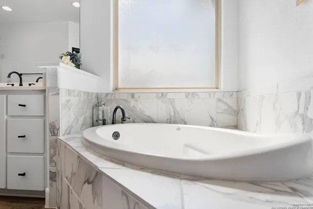 a bathroom with a bathtub and sink