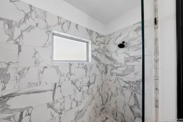 a bathroom with a bathtub and shower