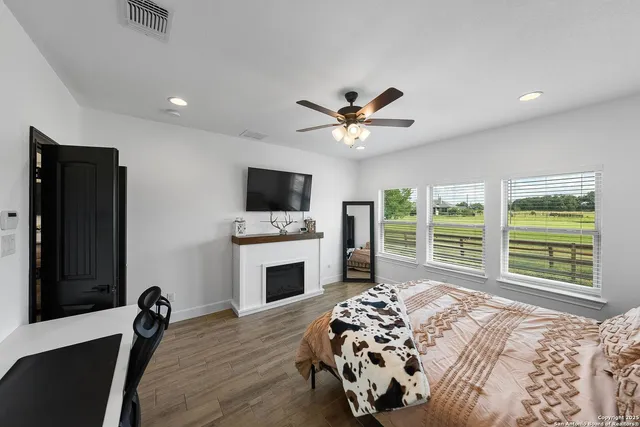 a bedroom with a bed and a large window