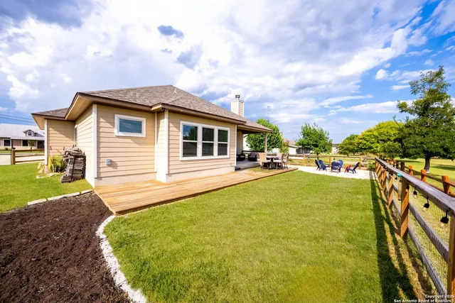 a view of a backyard with plants and a backyard