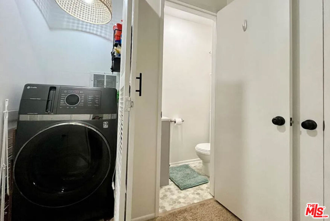 5829 Bowcroft Street, Unit 4 Los Angeles, CA 90016 - Photo 12 of 15 a view of a hallway with a washer and dryer