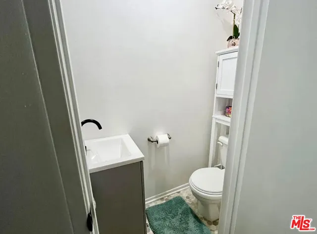 a white toilet sitting next to a sink