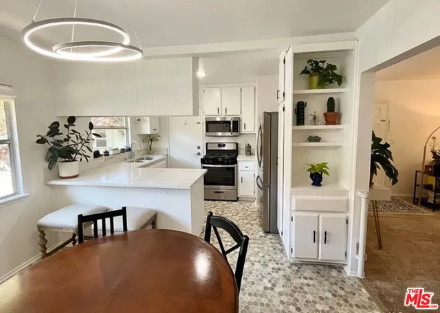 a kitchen with a table and chairs