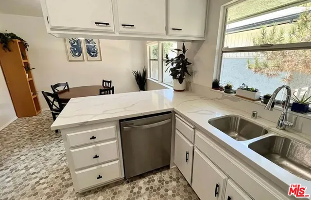 a kitchen with a sink stove and refrigerator