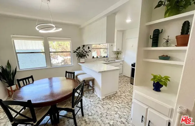 a view of a dining room with furniture and a window