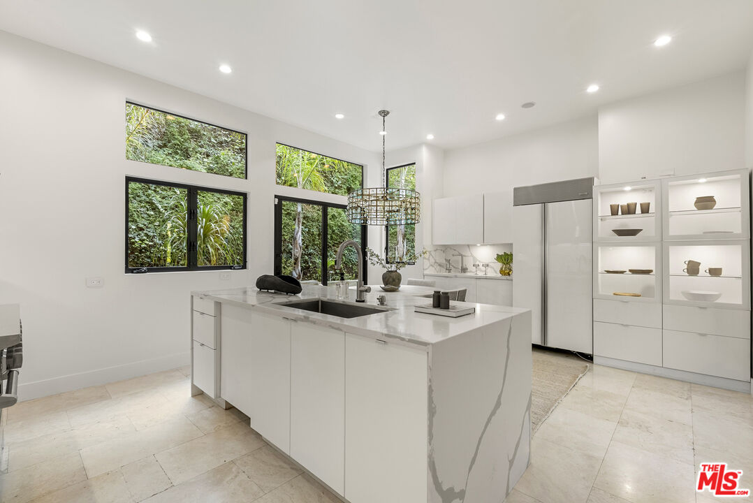 9782 Oak Pass Road Beverly Hills, CA 90210 - Photo 11 of 27 a kitchen with stainless steel appliances granite countertop a refrigerator and a sink