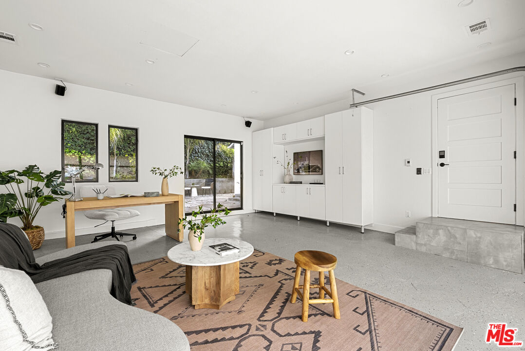 9782 Oak Pass Road Beverly Hills, CA 90210 - Photo 23 of 27 a living room with furniture and a large window