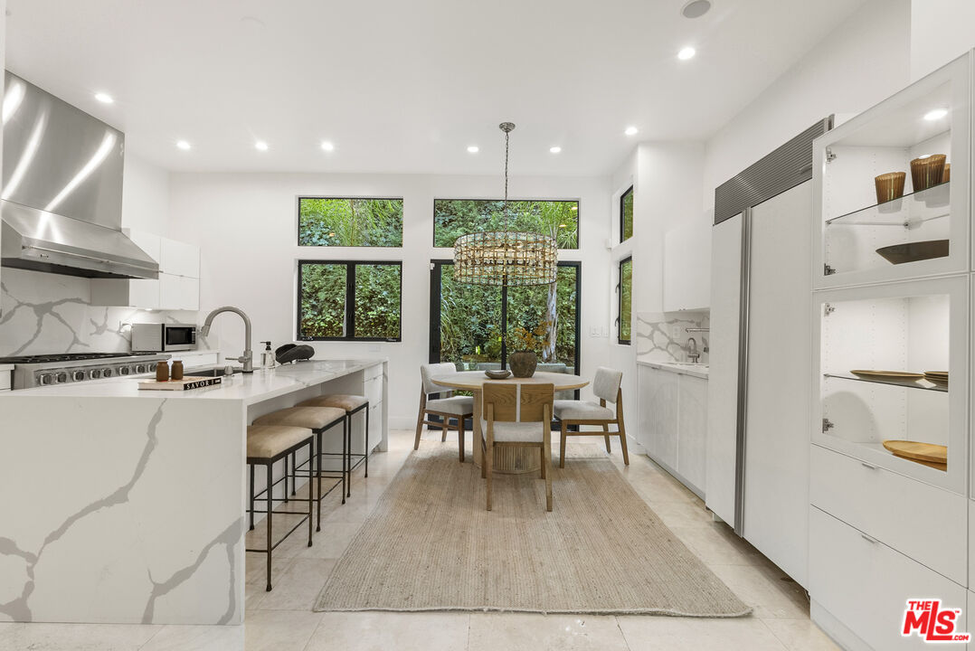 9782 Oak Pass Road Beverly Hills, CA 90210 - Photo 9 of 27 a living room with furniture a large window and wooden floor