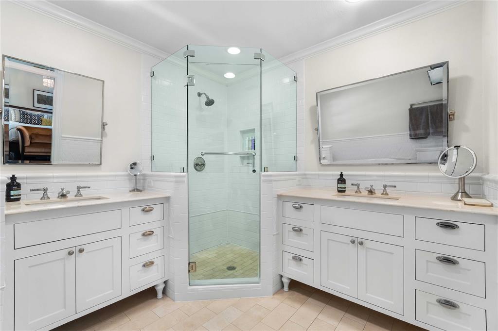 6841 Joyce Way Dallas, TX 75225 - Photo 9 of 13 Primary Bathroom with double vanity, bathtub and separate shower