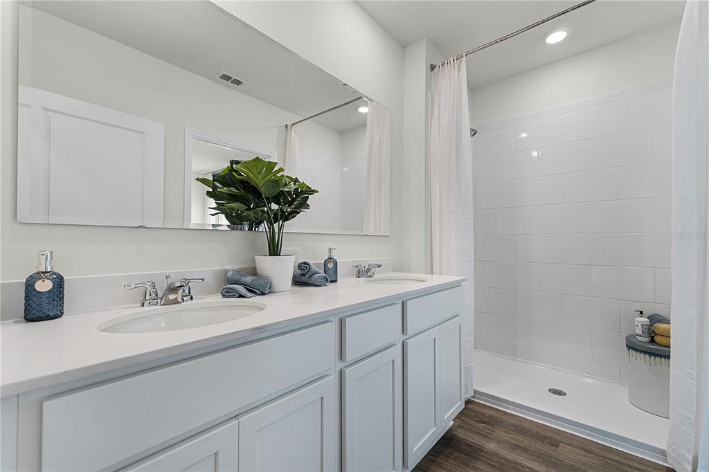 3390 Ft Mellon Lane Sanford, FL 32773 - Photo 12 of 24 a bathroom with a sink a shower and a mirror