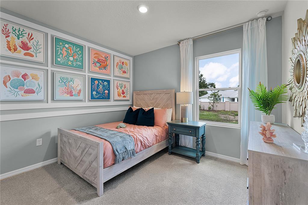 3390 Ft Mellon Lane Sanford, FL 32773 - Photo 15 of 24 a bedroom with a bed painting on the wall and a potted plant