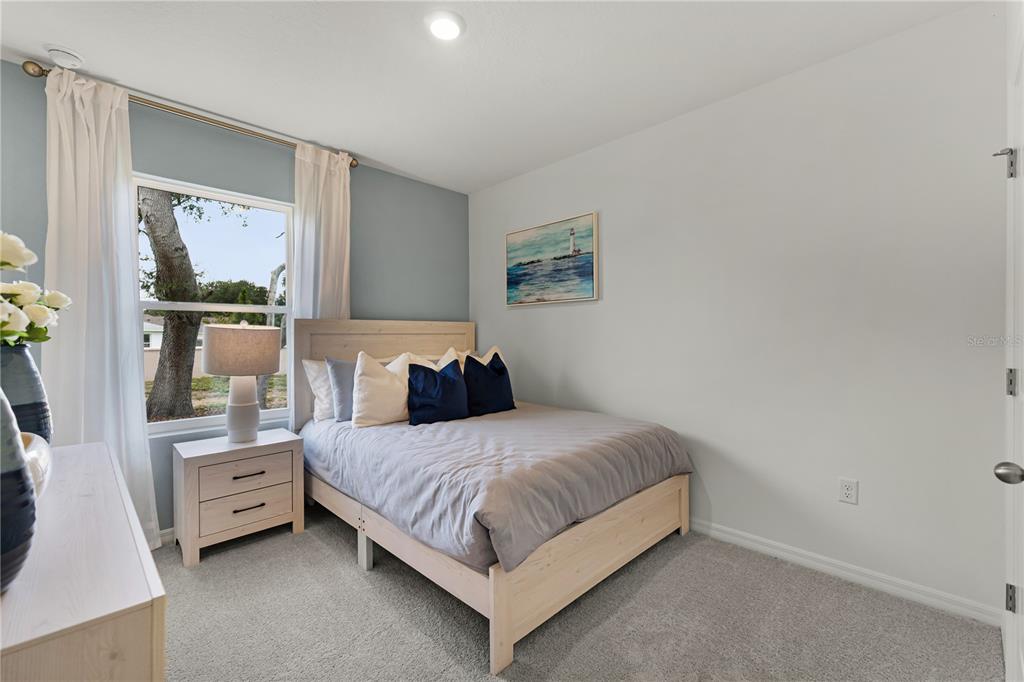 3390 Ft Mellon Lane Sanford, FL 32773 - Photo 16 of 24 a bedroom with a bed a large window and mirror