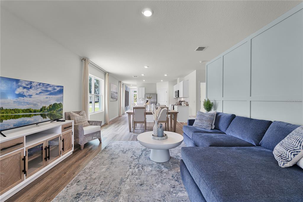 3390 Ft Mellon Lane Sanford, FL 32773 - Photo 9 of 24 a living room with furniture and a flat screen tv