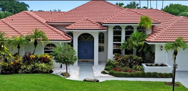 a front view of a house with a yard table and chairs