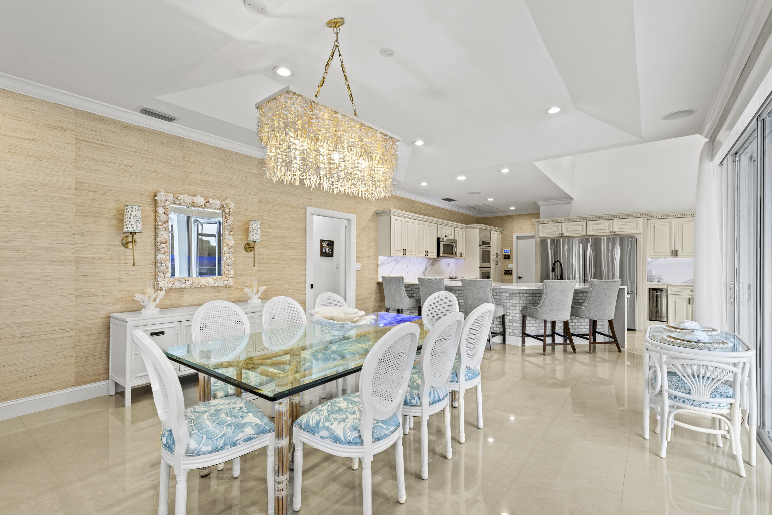 10431 Stonebridge Boulevard Boca Raton, FL 33498 - Photo 12 of 53 a dining room with furniture a chandelier and kitchen view