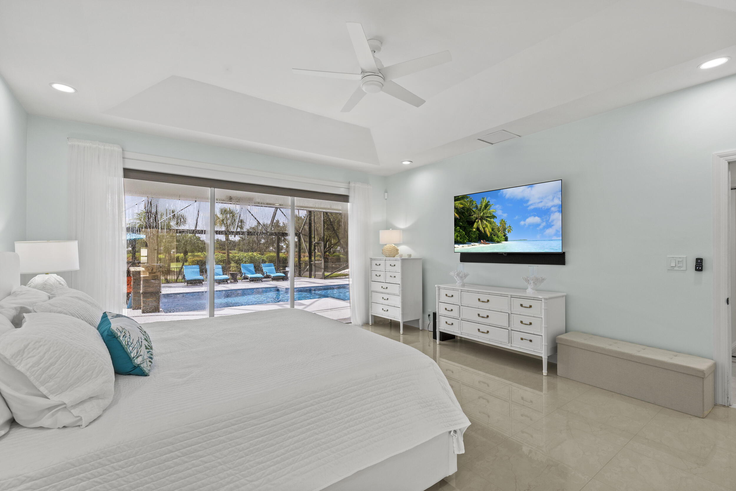 10431 Stonebridge Boulevard Boca Raton, FL 33498 - Photo 19 of 53 a bedroom with a bed and a flat screen tv
