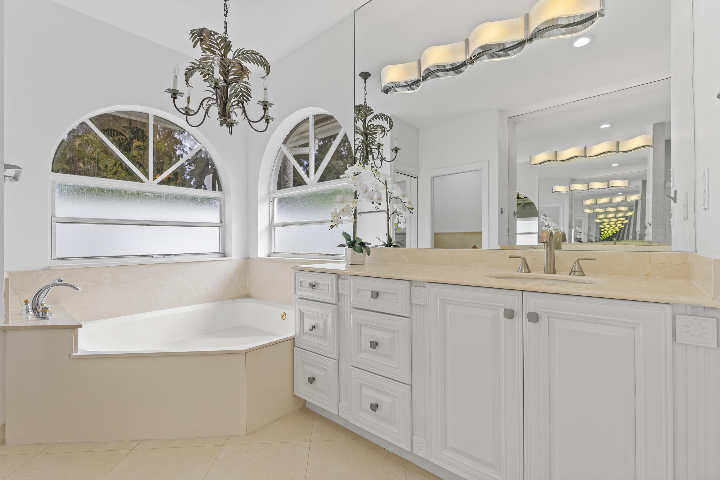 10431 Stonebridge Boulevard Boca Raton, FL 33498 - Photo 22 of 53 a bathroom with a sink a mirror and a bathtub