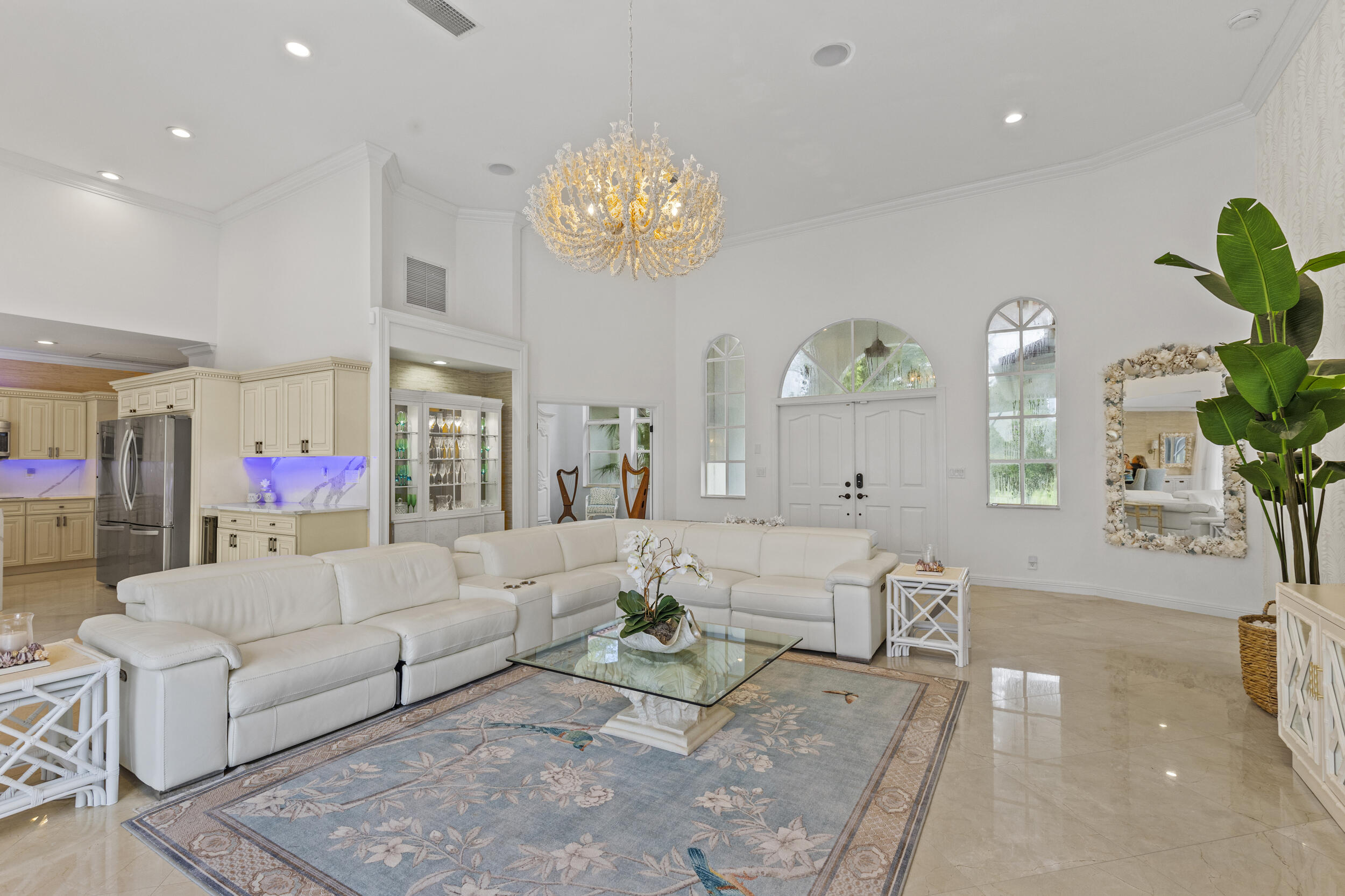 10431 Stonebridge Boulevard Boca Raton, FL 33498 - Photo 5 of 53 a living room with furniture and a chandelier