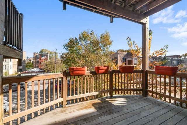 a view of a balcony with wooden floor