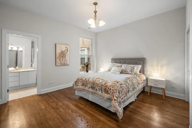a bedroom with a bed and a chandelier
