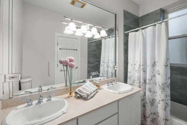 a bathroom with a sink double vanity and a mirror
