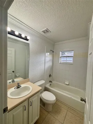 a bathroom with a toilet a sink a mirror and a bathtub