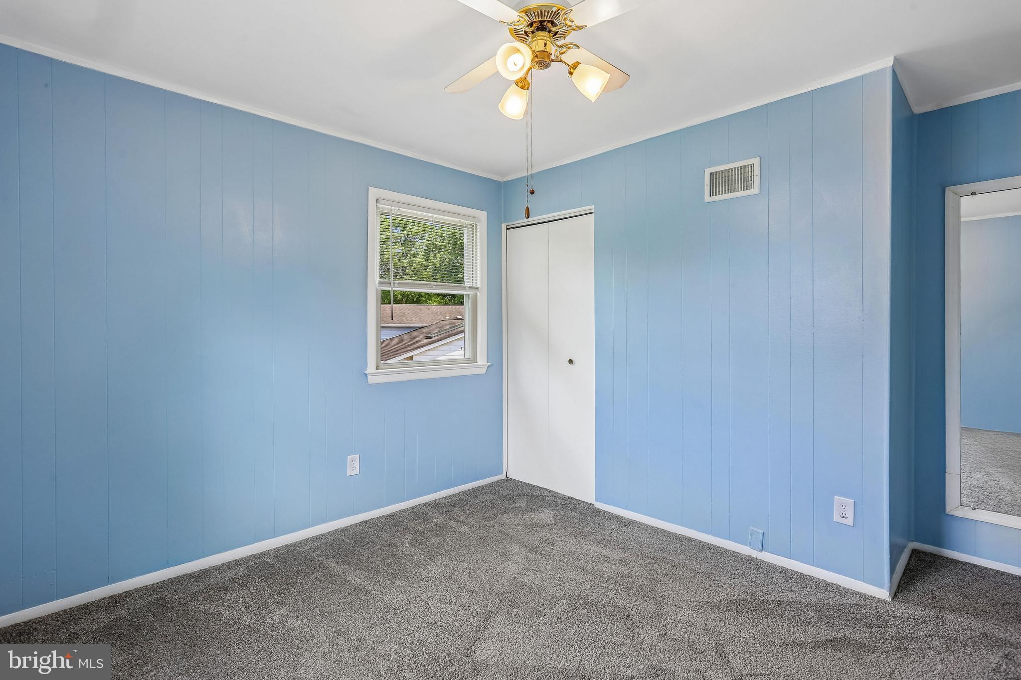 2 Foxhall Court Silver Spring, MD 20906 - Photo 45 of 86 an empty room with a window and a chandelier fan