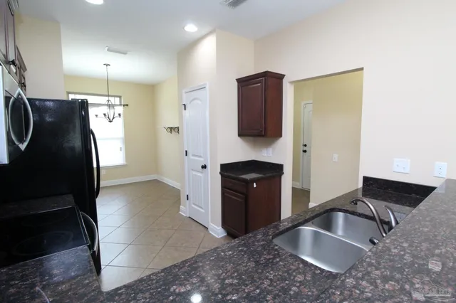 a kitchen with a refrigerator and a sink
