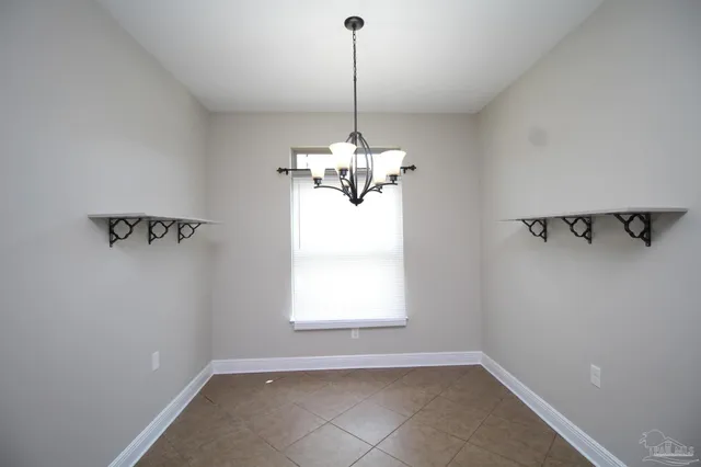 a dining room with a window and a chandelier