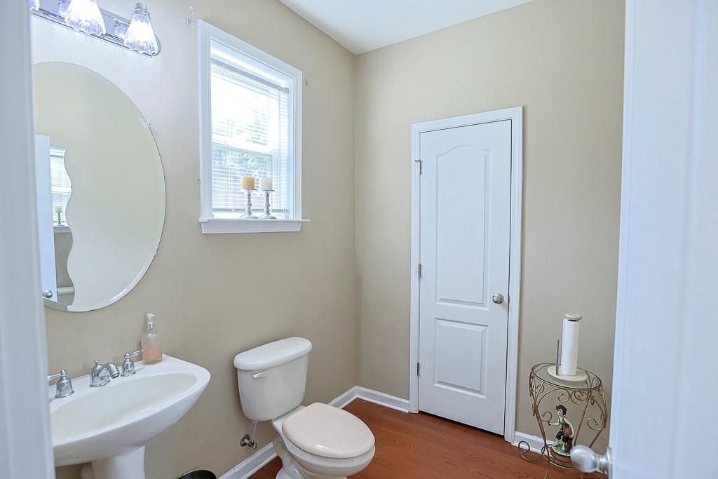 300 Hampton Place Canton, GA 30115 - Photo 30 of 82 a bathroom with a toilet a sink and mirror