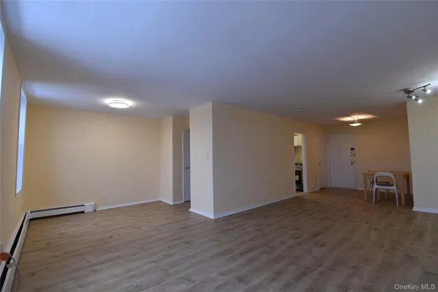 a view of a room with wooden floor