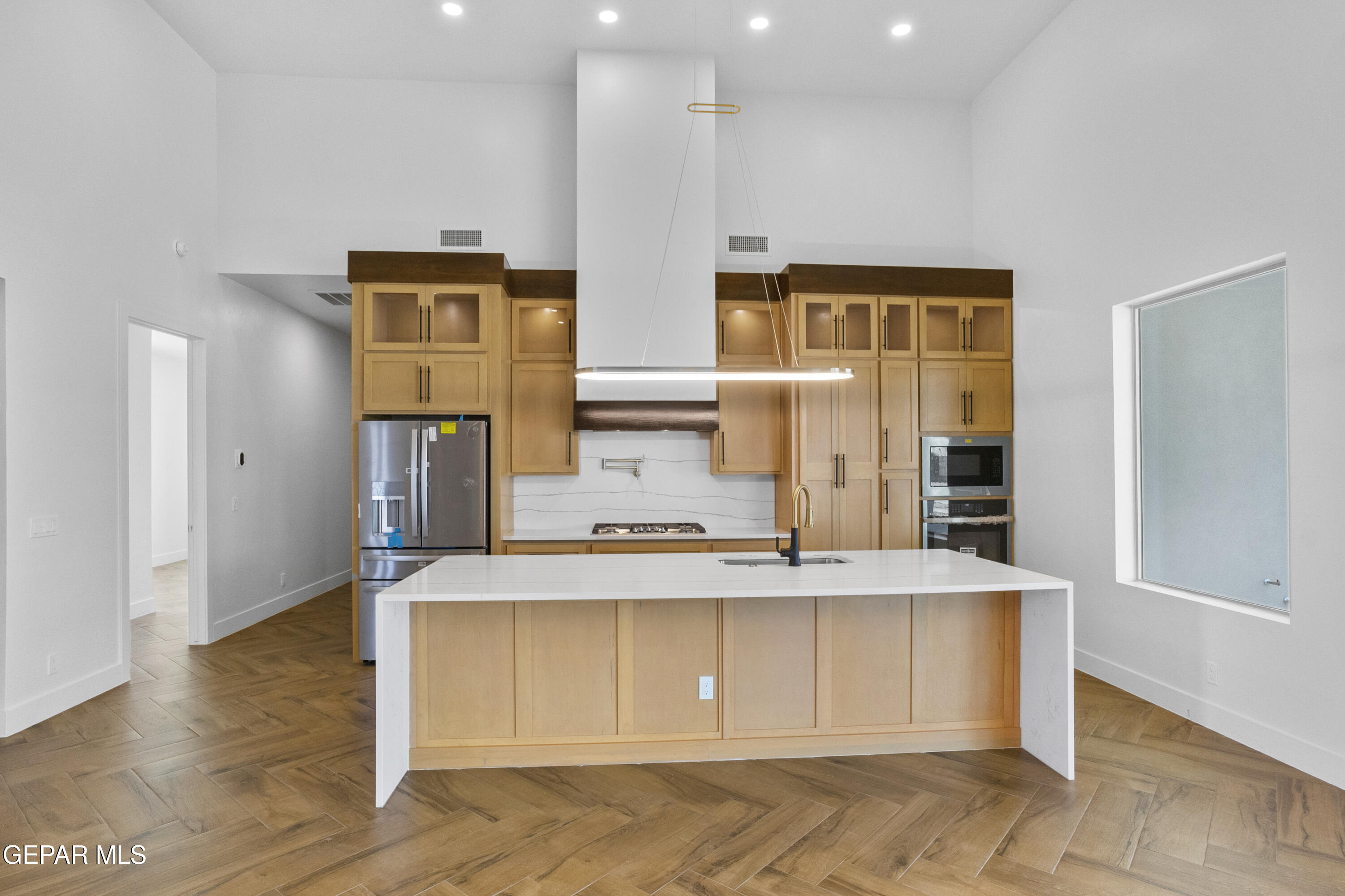 5699 Rio Bonito Circle El Paso, TX 79932 - Photo 12 of 25 a view of a kitchen with kitchen island a counter top space and stainless steel appliances