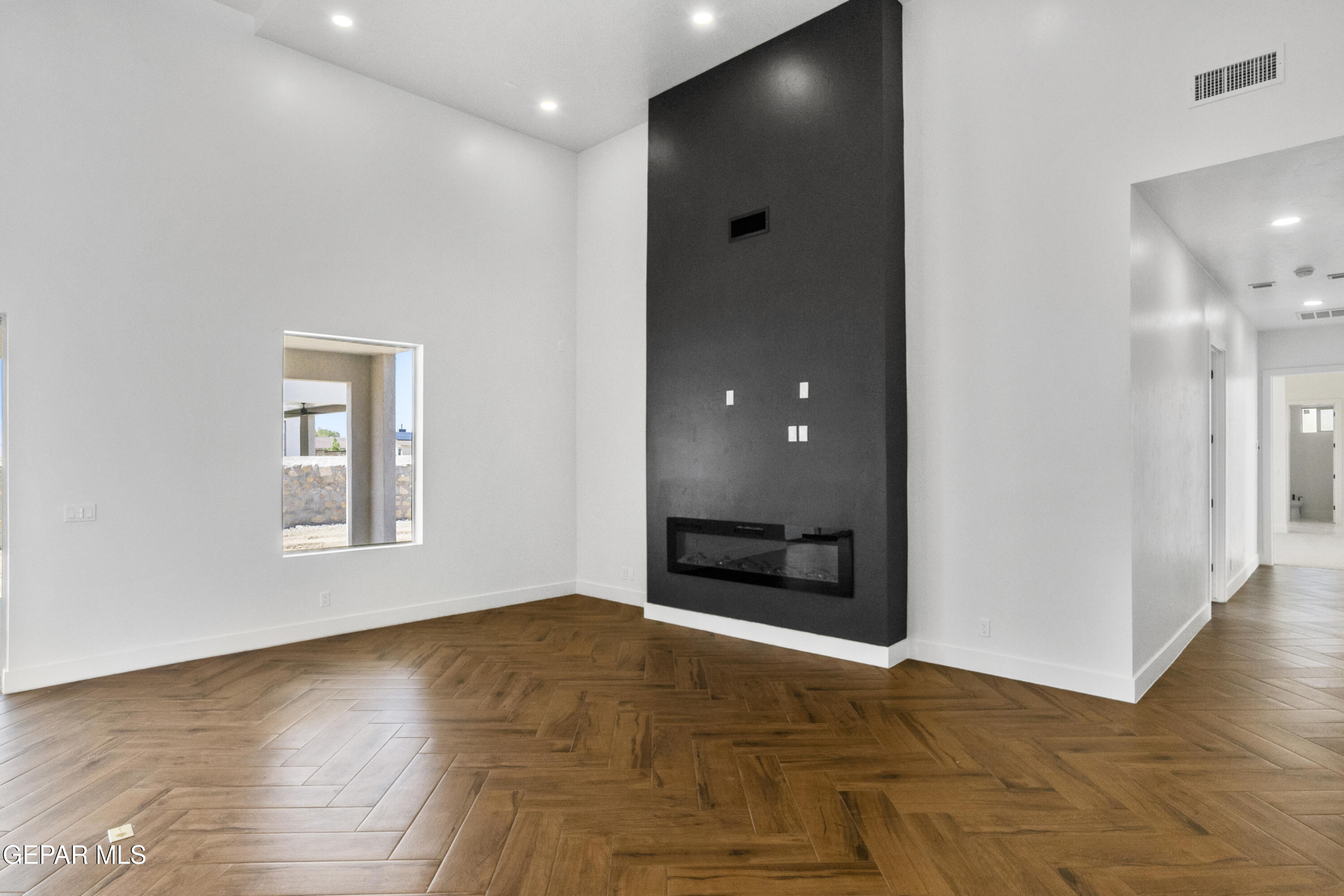 5699 Rio Bonito Circle El Paso, TX 79932 - Photo 14 of 25 a view of an empty room with wooden floor and a window