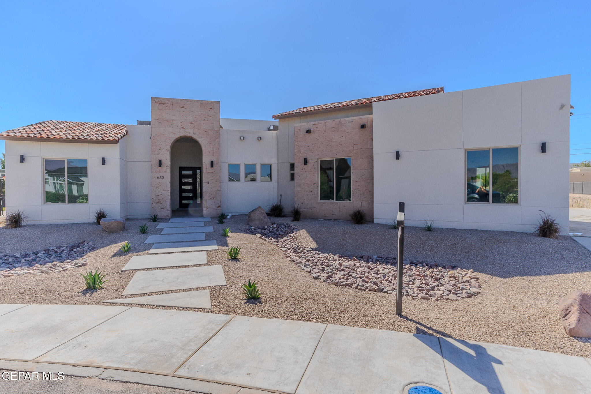 5699 Rio Bonito Circle El Paso, TX 79932 - Photo 2 of 25 a front view of a house with garden