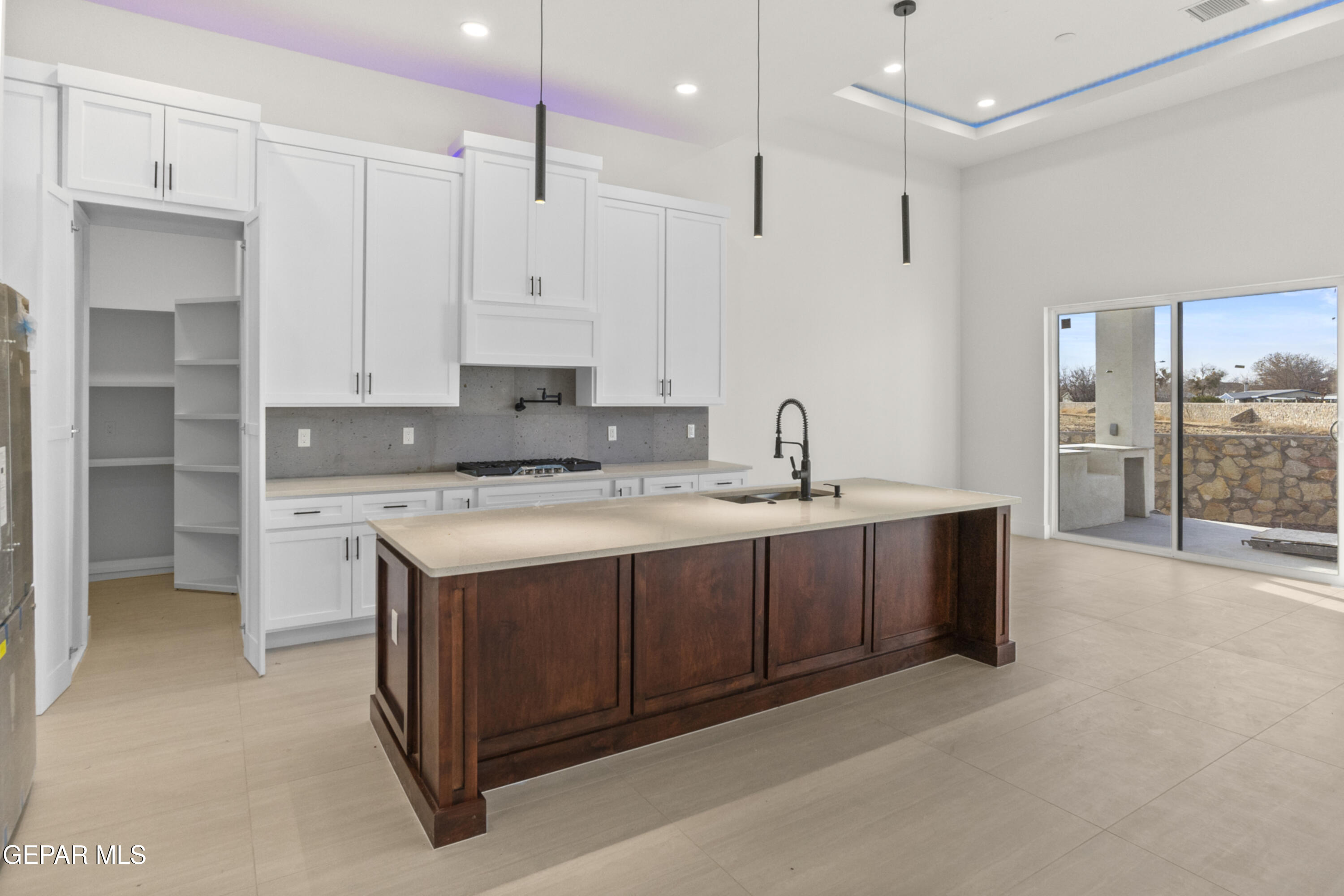 5699 Rio Bonito Circle El Paso, TX 79932 - Photo 22 of 25 a kitchen with a sink stove and cabinets