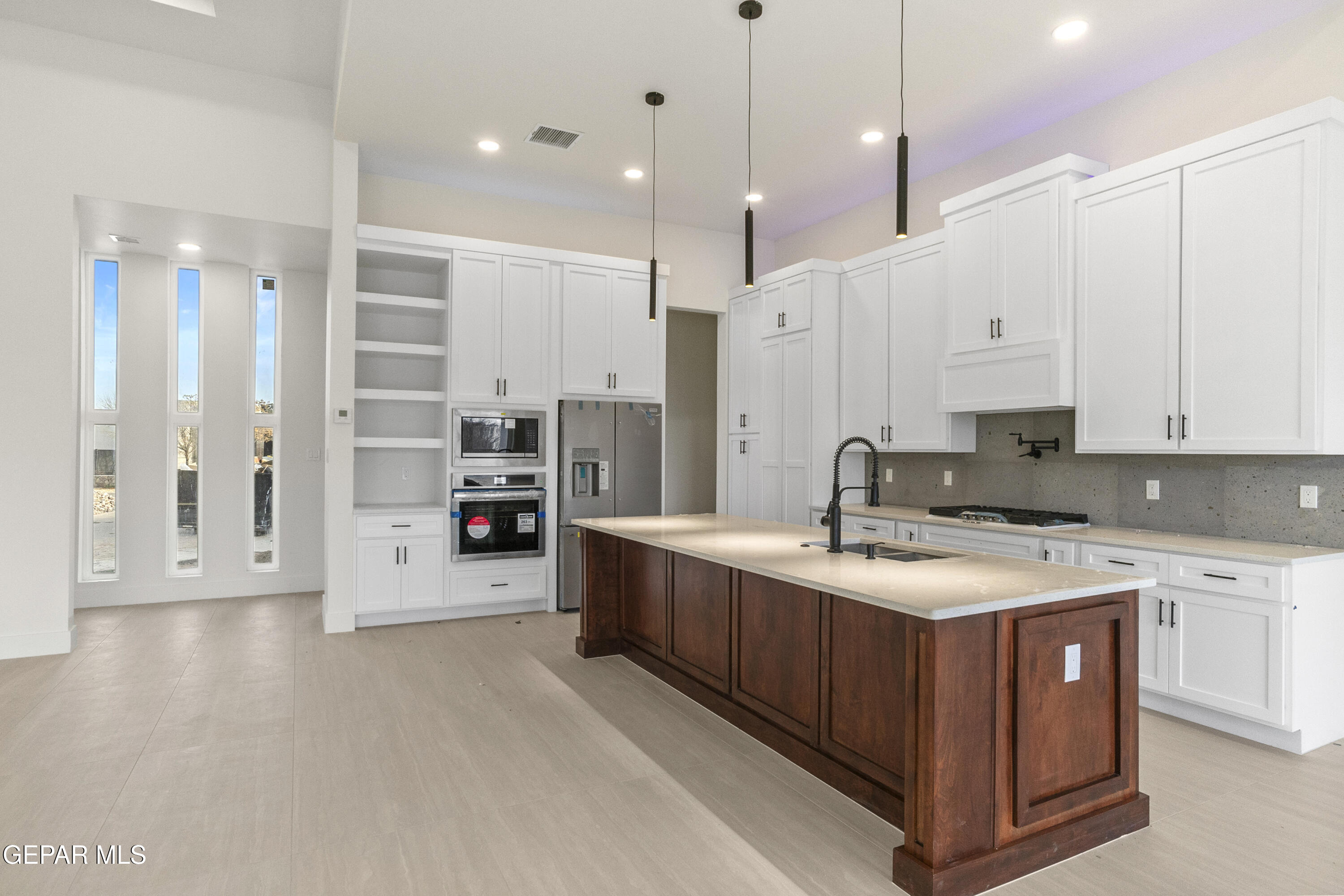 5699 Rio Bonito Circle El Paso, TX 79932 - Photo 23 of 25 a large kitchen with stainless steel appliances sink a stove and a refrigerator