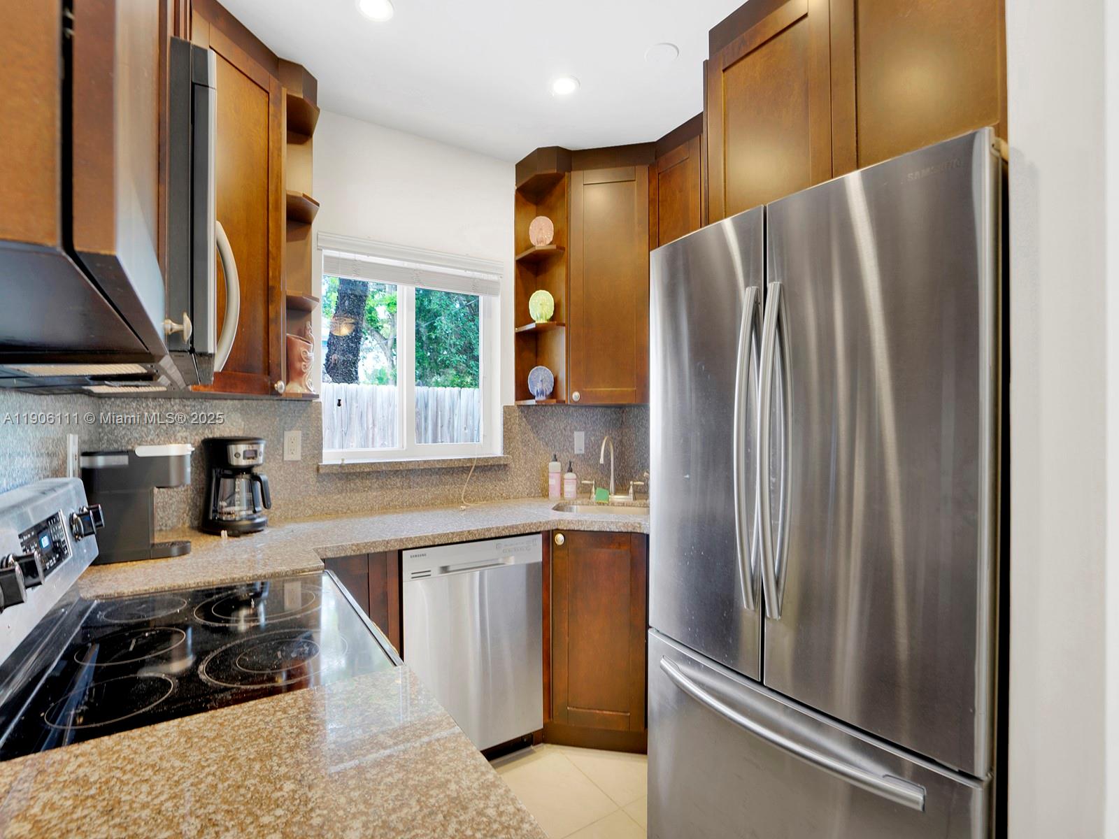 3547 William Avenue Miami, FL 33133 - Photo 12 of 20 a kitchen with stainless steel appliances granite countertop a refrigerator a stove and a sink with wooden floor