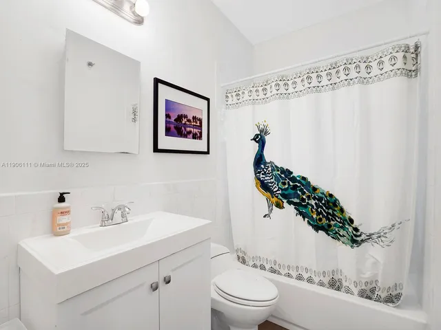 a bathroom with a toilet a sink and a mirror