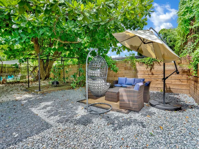 a view of a backyard with plants and patio