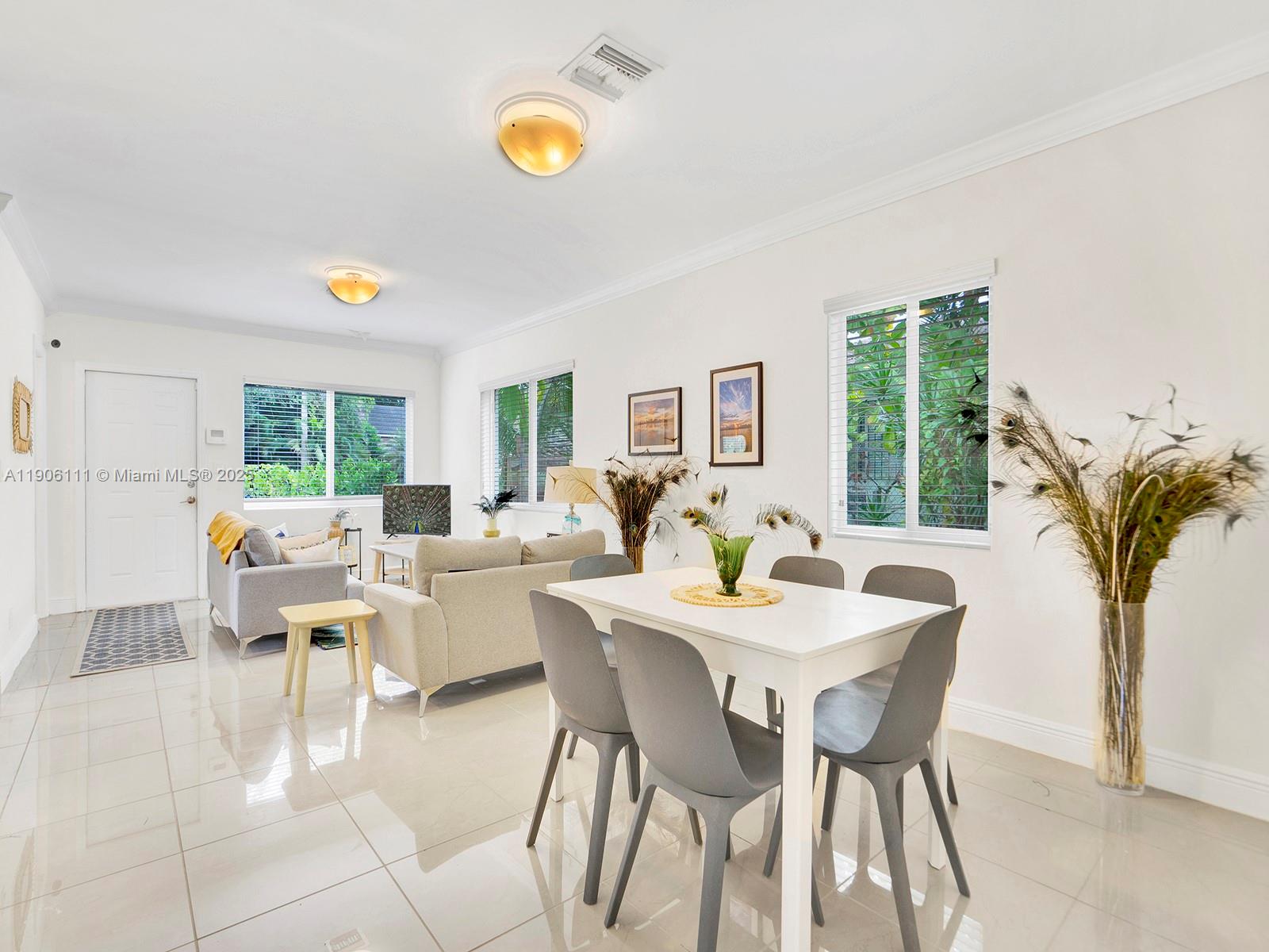 3547 William Avenue Miami, FL 33133 - Photo 6 of 20 a view of a dining room with furniture and a potted plant