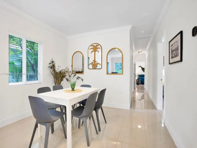 a view of a dining room with furniture and window