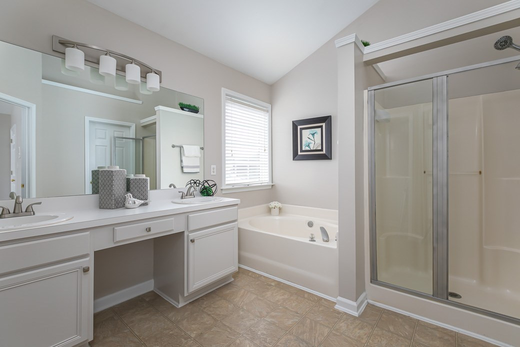 5400 Cahaba Way Raleigh, NC 27616 - Photo 6 of 13 The Master Bathroom features NEW FIXTURES, a spacious vanity with two sinks and a separate shower. There is a GARDEN TUB with a large window which allows natural light to flood the room creating a peaceful atmosphere. Master Bathroom