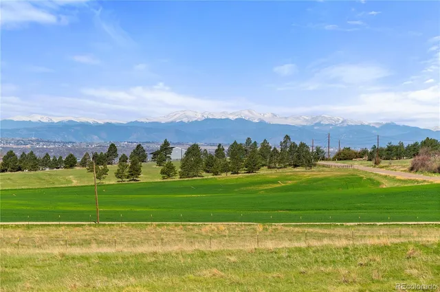 an aerial view of a house with swimming pool and big yard